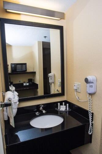 a bathroom with a sink and a large mirror at Fairfield Inn & Suites by Marriott Boston Milford in Milford