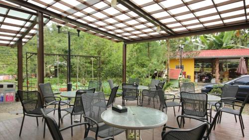 a group of tables and chairs on a patio at Chin Pin Lo B&B in Yuchi