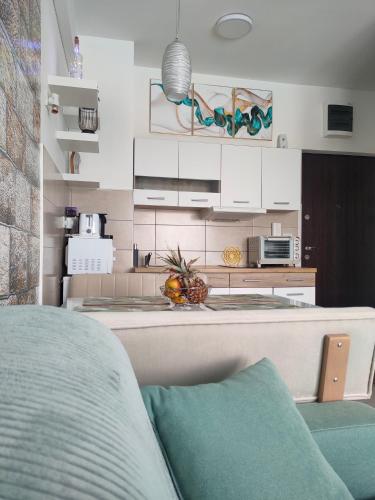 a kitchen with white cabinets and a counter top at Apartment Tropical - Aqua Park Jagodina in Jagodina