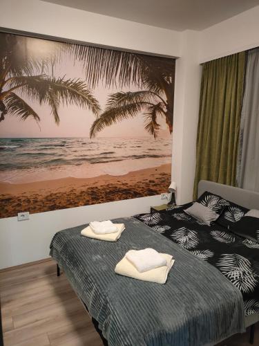a bedroom with two beds and a painting of the beach at Apartment Tropical - Aqua Park Jagodina in Jagodina