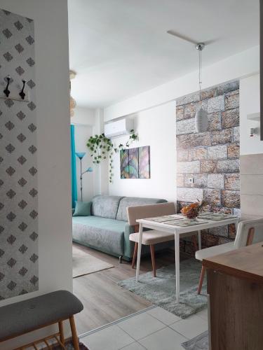 a living room with a couch and a table at Apartment Tropical - Aqua Park Jagodina in Jagodina