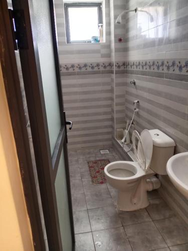 a bathroom with a toilet and a sink at Home away from home Next to Sky Louge Bamburi in Mombasa