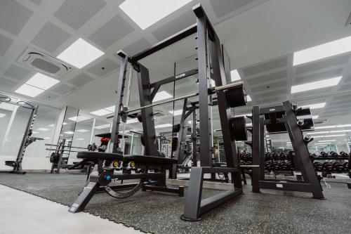 a gym with a mirror and equipment in a room at Best Western Plus Batumi in Batumi