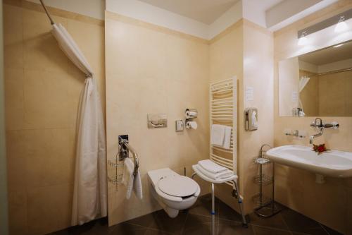 a bathroom with a toilet and a sink at Boutique Hotel Maraton in Košice