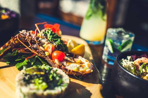 a table topped with plates of food on a table at Paradis Plage Surf Yoga & Spa in Taghazout