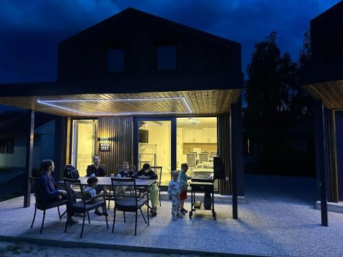 a group of people sitting at a table in a house at ARIA DELUXE Mobile Homes with Terme Čatež Tickets in Čatež ob Savi
