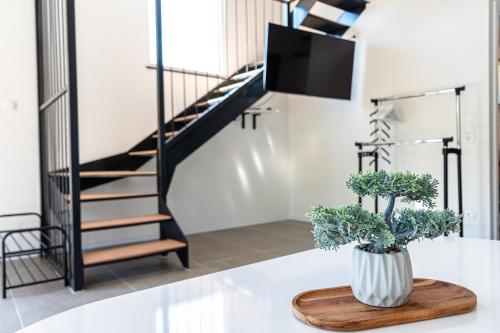 a vase on a table in a room with a staircase at ARIA DELUXE Mobile Homes with Terme Čatež Tickets in Čatež ob Savi