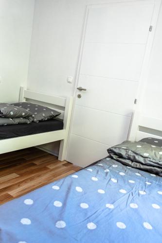 a bedroom with two bunk beds and a blue rug at ARIA DELUXE Mobile Homes with Terme Čatež Tickets in Čatež ob Savi