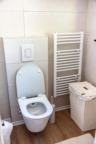 a bathroom with a white toilet and a basket at ARIA DELUXE Mobile Homes with Terme Čatež Tickets in Čatež ob Savi