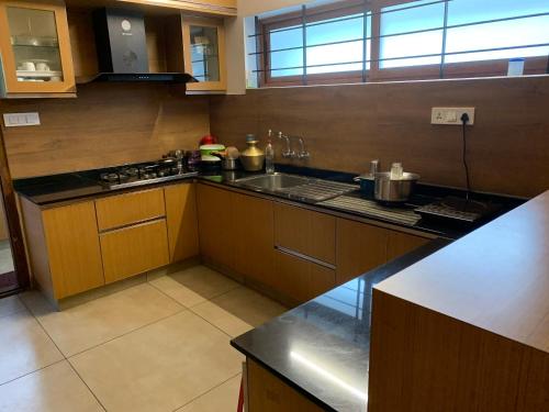 a kitchen with a sink and a counter top at Nirvana Home stay TVM -allure in Trivandrum