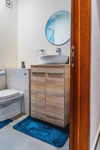 a bathroom with a sink and a mirror at Park Apartments in Accra