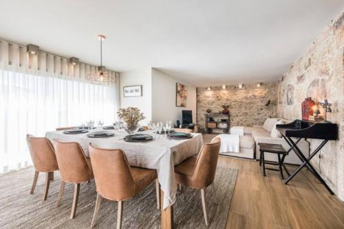 a dining room with a table and a piano at Casa Pelourinho de Louredo with pool in Paredes