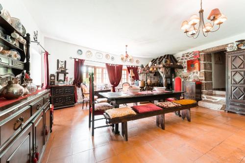 a kitchen with a table and a dining room at Casa Museu da Geada: Room 2 in Cinfães