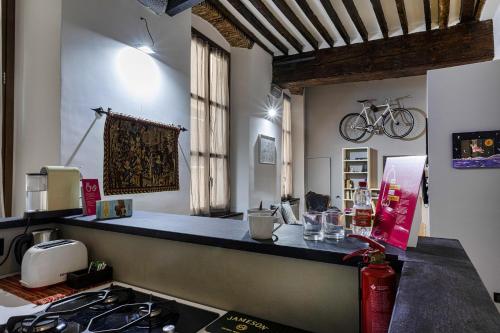 a kitchen with a counter and a bike on the wall at Alle Mura del Molo Apartment by Wonderful Italy in Genoa