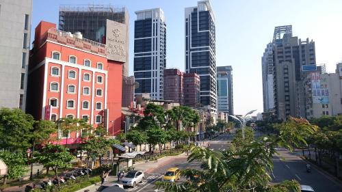 a street in a city with tall buildings at MRT Hotel in Taipei