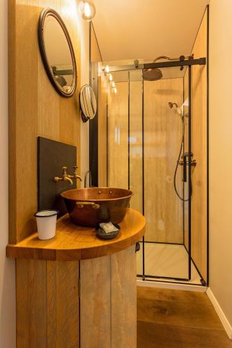 a bathroom with a sink and a glass shower at Holly Lodge Boutique B&B in Thursford