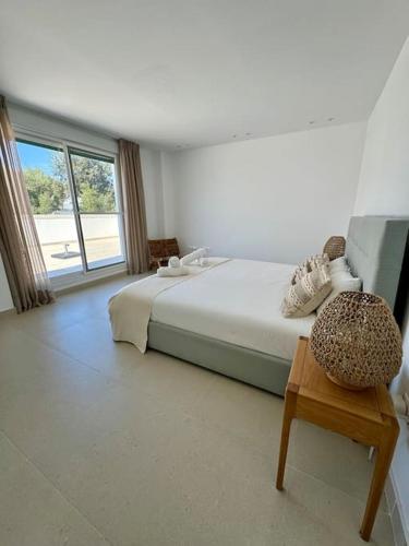a bedroom with a large bed and a table at Spacieux Appartement 3 chambres Reserva Sotogrande in San Roque