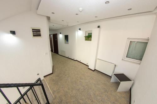 a hallway with white walls and a chalkboard on the wall at Hotel Hayat in Sarajevo