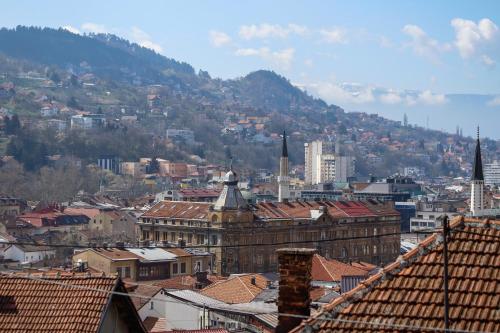 a view of a city with buildings and a mountain at Hotel Hayat in Sarajevo
