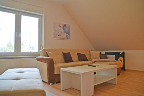 sala de estar con sofá y mesa en Ferienwohnung Wiesenblick, en Kerkwitz