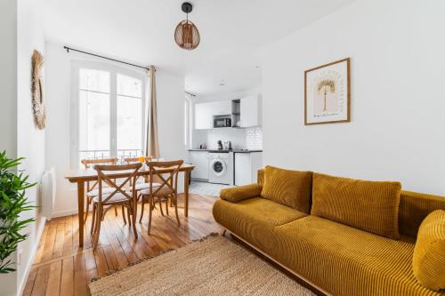 un salon avec un canapé et une table dans l'établissement Jolie 2 pièces proche métro - Paris 19 - 4p - FLAT-GUEST, à Paris
