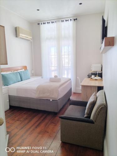 a bedroom with a bed and a couch at HEBA GUEST LODGE in Uitenhage