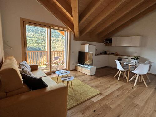 a living room with a couch and a kitchen at I Ciliegi del Conte in Bormio