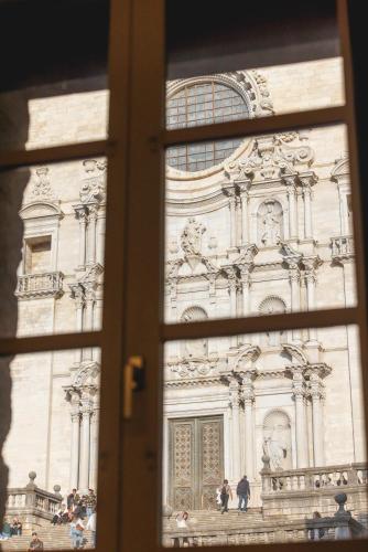 a view of a building through a window at Bravissimo Catedral, with monumental views in Girona