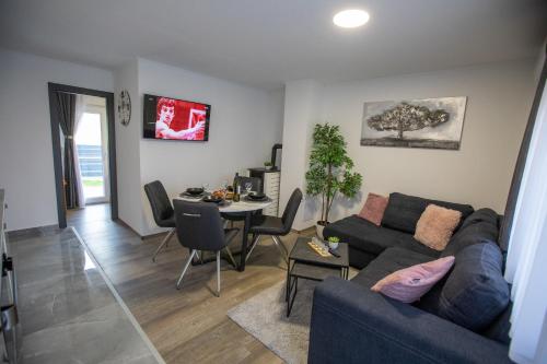 a living room with a couch and a table at APARTMANI TEA in Ogulin