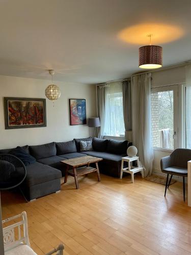 a living room with a couch and a table at Lejlighed med udsigt til Frederiksberg have in Copenhagen