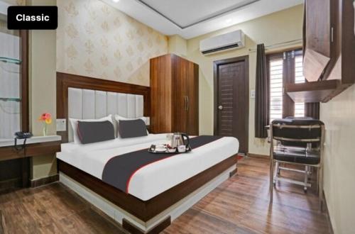 a bedroom with a large bed and a desk at HOTEL CITI STAR in Bareilly