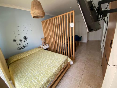 1 dormitorio pequeño con 1 cama y TV en departamento boutique zona aldrey en Mar del Plata