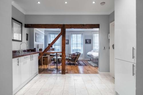 a kitchen with white cabinets and a dining room at LiveStay-Fabulous One Bed Apartments on Covent Garden in London