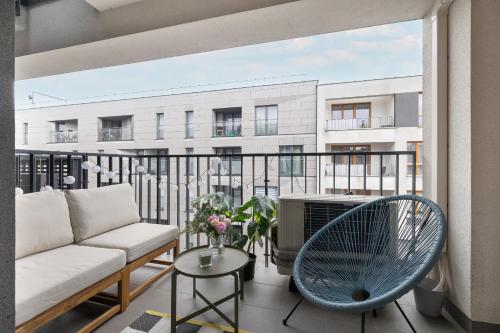 - Balcón con sofá y silla en Ślusarska Modern Apartment with Balcony & Parking Cracow Zabłocie by Renters Prestige en Cracovia