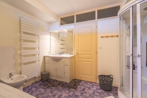 a bathroom with a sink and a toilet and a mirror at La Maison Télémaque in Marennes