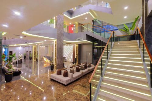 a lobby with a staircase in a building at 1O1 STYLE Yogyakarta Malioboro in Sentool