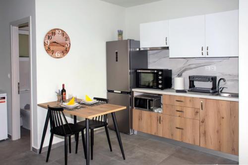 a kitchen with a table with chairs and a refrigerator at Kolymvari Hills in Chania Town