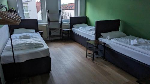 a room with two beds and a window at Sali-Homes Boarding Haus Monteur-Wohnungen Balkon Vollküche Autobahnähe in Markranstädt