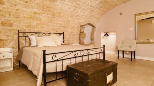 a bedroom with a bed in a stone wall at LA DIMORA casa vacanze di charme in Molfetta