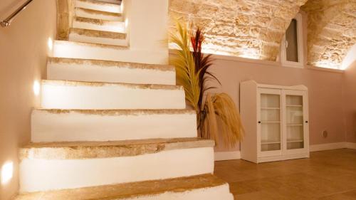 a white staircase in a room with a door at LA DIMORA casa vacanze di charme in Molfetta