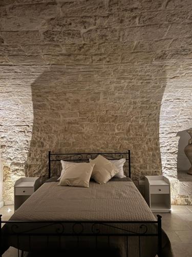 a bedroom with a bed and a brick wall at LA DIMORA casa vacanze di charme in Molfetta