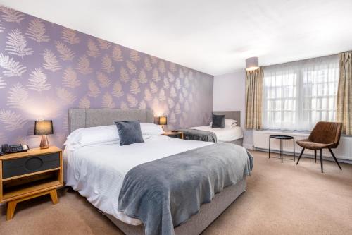 a bedroom with a large bed and a wall mural at Dornoch Castle Hotel in Dornoch