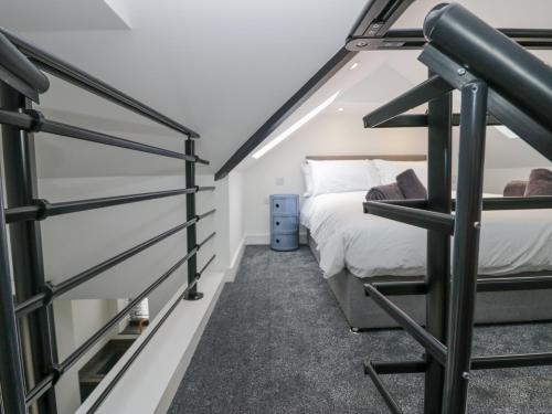 a bedroom with two bunk beds and a staircase at Driftwood Studio in Ulverston