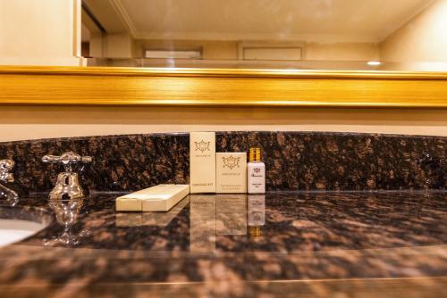 a bathroom counter with a sink and a mirror at City Nest - Michelangelo Towers in Johannesburg