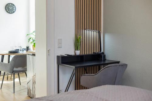 a bedroom with a desk and a table and chairs at Apart21 - Exclusive Apartments in Central location with Parking in Ingolstadt