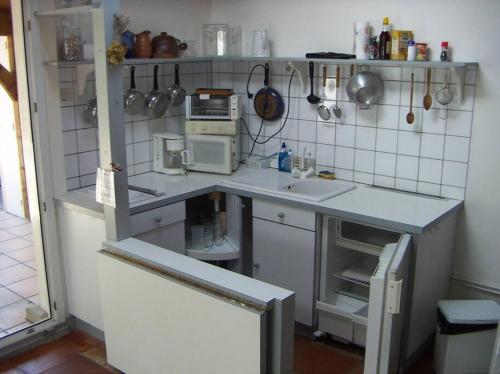 a small kitchen with a counter with a sink at Villa centre-ville proche plage -6264 in Soulac-sur-Mer