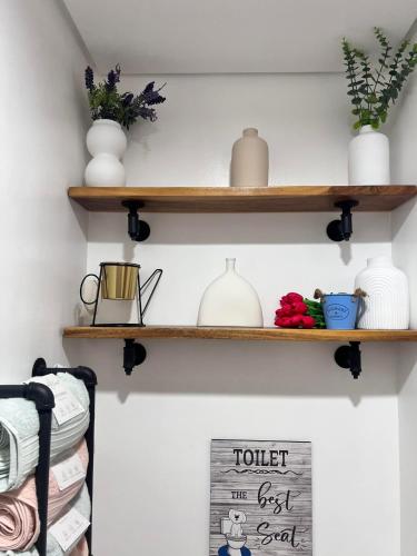 a room with wooden shelves on the wall with a sign at SMDC Green 2 Staycation, The Traditional & Modern Fusion Condo in Pasong Bayog