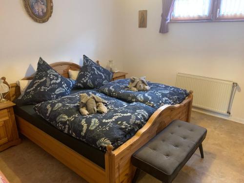 a bed with two stuffed animals sitting on it at Uschi's Familienparadies in Monschau