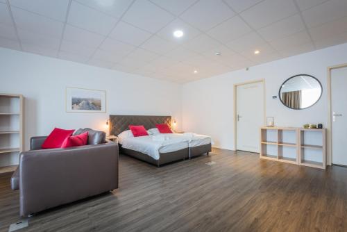 a large bedroom with a bed and a couch at Los Lorentes Apartments Bern Airport in Belp