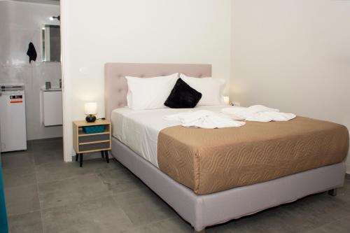 a bed with white sheets and pillows in a room at Kolymvari Hills in Chania Town